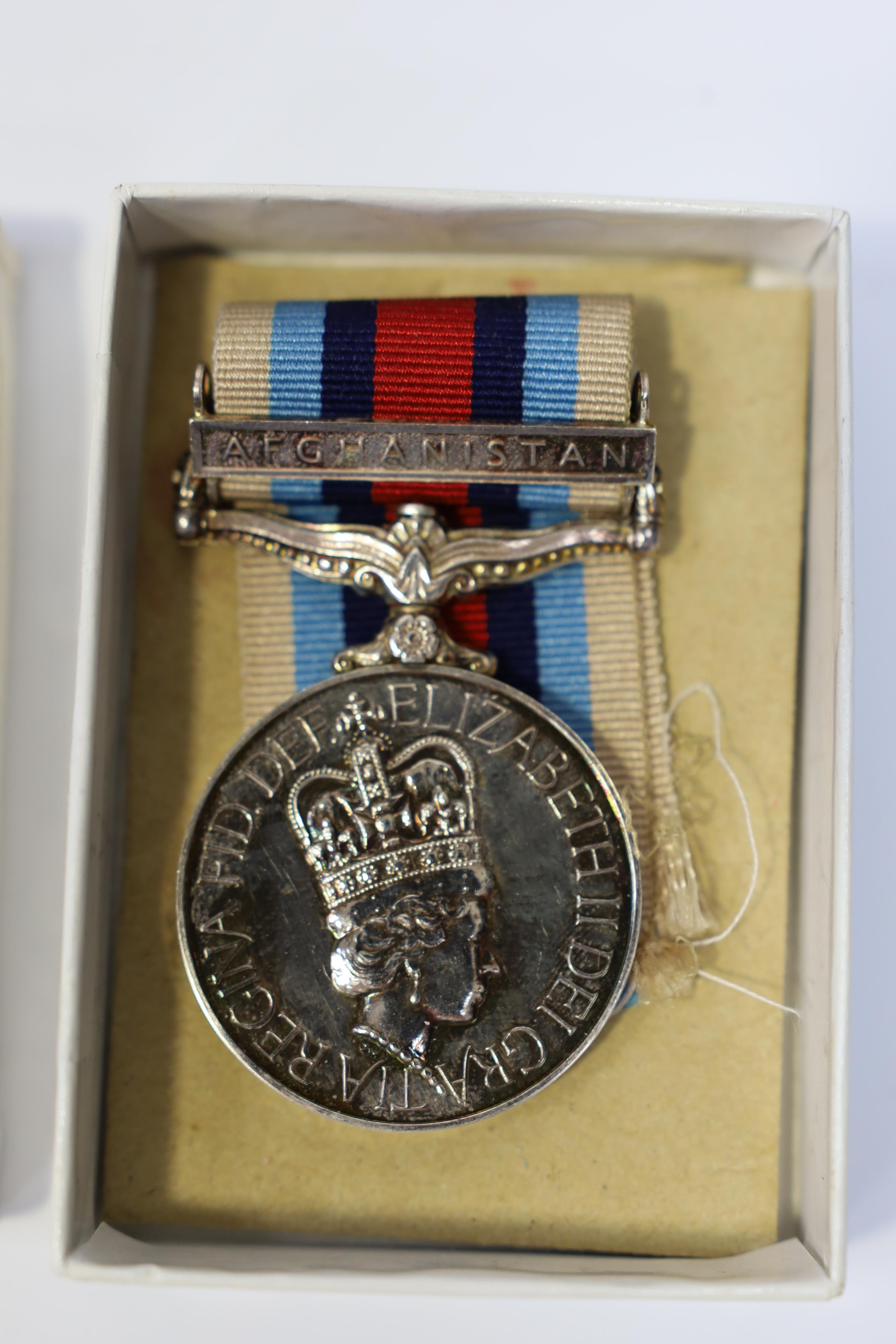 An ERII Operational Service Medal for Afghanistan awarded to Sgt. A.J. Pugsley RAMC (R), together with a Korea medal pair awarded to Sigmn. A.G. Lickman R.Sigs., all in separate issue boxes. Condition - fair to good